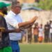 Ivan Minnaert and Matthew Saygba Julutweh on the FC Fassell sidelines during a match in Monrovia, Liberia.