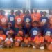 Group photo of young boys and girls in branded Flames Basketball and LBA jerseys during youth training camp at Stella Maris Gym in Monrovia, Liberia.