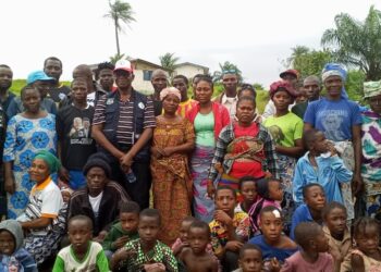 Former Ivorian refugees pose with LRRRC officials during residence permit campaign in Zwedru, Grand Gedeh County, Liberia.