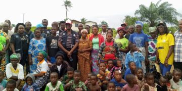 Former Ivorian refugees pose with LRRRC officials during residence permit campaign in Zwedru, Grand Gedeh County, Liberia.