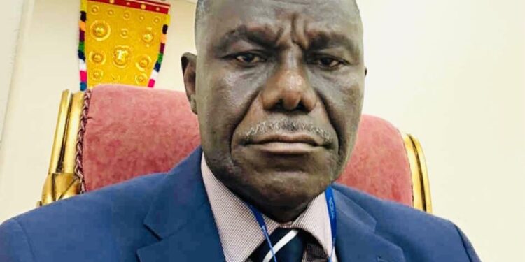 Former Deputy Transport Minister J. Ebenezer Kolliegbo sits in his office, sharply criticizing the outsourcing of vehicle licensing to a foreign-controlled firm.