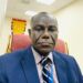 Former Deputy Transport Minister J. Ebenezer Kolliegbo sits in his office, sharply criticizing the outsourcing of vehicle licensing to a foreign-controlled firm.
