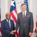 Liberian President Joseph Boakai shakes hands with U.S. Deputy Secretary of State Christopher Landau during a bilateral meeting in Washington, D.C., flanked by Liberian and American flags