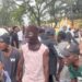 Masked and unmasked youth protestors shouting during July 17 protest in Monrovia, Liberia.
