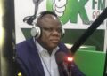 Christopher D. Sankolo, suspended Director General of LACRA, speaks during a radio interview at OK FM amid financial misconduct allegations related to a UBA account.