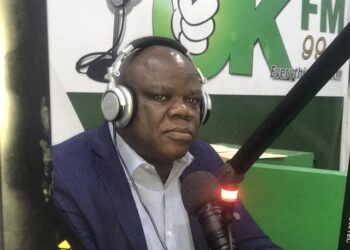 Christopher D. Sankolo, suspended Director General of LACRA, speaks during a radio interview at OK FM amid financial misconduct allegations related to a UBA account.