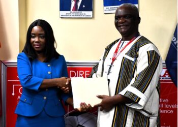 LACC Chairperson Cllr. Alexandra Zoe and LRA Commissioner General James Dorbor Jallah shake hands after announcing 100% asset declaration compliance