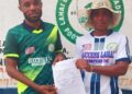 Francisco T. Hinneh receives appointment letter as head coach of Lahai Dream United Football Academy, flanked by a club official in front of the team’s logo in St. Paul Bridge, Liberia.