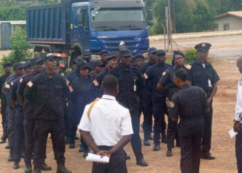 Liberia National Police officers receive briefing during deployment ceremony in Nimba County