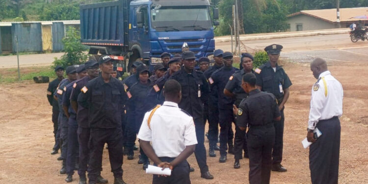 Liberia National Police officers receive briefing during deployment ceremony in Nimba County