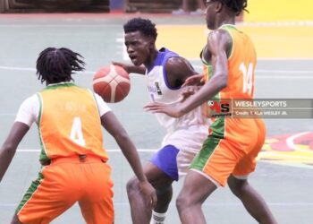 Liberia U-16 guard drives between two Benin defenders during a 98-38 victory at the FIBA AfroBasket Zone 3 qualifiers in Paynesville
