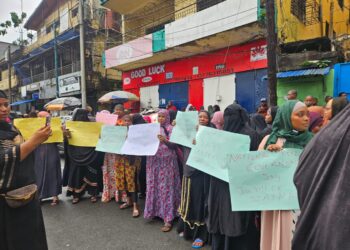 Fula Muslim women hold signs and protest peacefully on Carey Street in Monrovia, demanding justice after police allegedly removed a woman’s hijab during a raid on July 23, 2025.