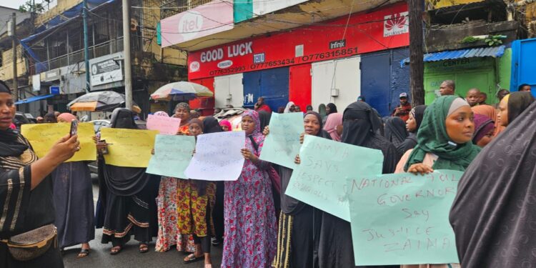 Fula Muslim women hold signs and protest peacefully on Carey Street in Monrovia, demanding justice after police allegedly removed a woman’s hijab during a raid on July 23, 2025.