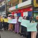Fula Muslim women hold signs and protest peacefully on Carey Street in Monrovia, demanding justice after police allegedly removed a woman’s hijab during a raid on July 23, 2025.