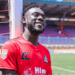 Liberian forward Mark Yallah smiles in his new Vipers SC jersey after completing his move to the Ugandan football champions.