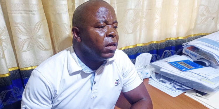 NEC Upper Nimba Magistrate Milton Paye discusses voter card replacement statistics in his Sanniquellie office