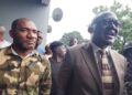 Senator Momo Cyrus flanked by police and protesters after chaos erupted at Capitol Hill during the Enough is Enough protest in Monrovia