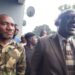 Senator Momo Cyrus flanked by police and protesters after chaos erupted at Capitol Hill during the Enough is Enough protest in Monrovia
