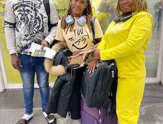Three NaFAA staff members at an airport en route to China for a fisheries value chain training program aimed at enhancing Liberia’s fishery sector.