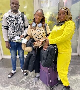 Three NaFAA staff members at an airport en route to China for a fisheries value chain training program aimed at enhancing Liberia’s fishery sector.