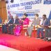 Panelists, including private sector and government leaders, seated on stage during Liberia Technology Summit 2025 in Monrovia, themed “Transforming Governance, Empowering Citizens.”