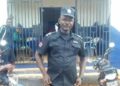 Chief Inspector Patrick Sendolo in uniform outside a Liberia National Police station in Gbarnga, Bong County