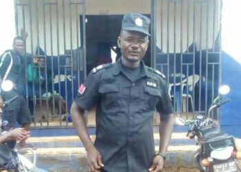 Chief Inspector Patrick Sendolo in uniform outside a Liberia National Police station in Gbarnga, Bong County