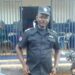 Chief Inspector Patrick Sendolo in uniform outside a Liberia National Police station in Gbarnga, Bong County