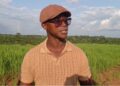 Quanuquanei Alfred Karmue stands on farmland cultivated by Panta Pride in Bong County, Liberia.