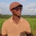 Quanuquanei Alfred Karmue stands on farmland cultivated by Panta Pride in Bong County, Liberia.