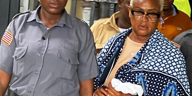 Rita Sarta William escorted by prison officer after being sentenced for drug trafficking at Criminal Court C in Monrovia