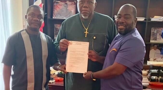 Senator Bill Twehway receives appointment letter as board chair of Senior Female Professionals FC from club officials at his Capitol Building office.