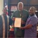 Senator Bill Twehway receives appointment letter as board chair of Senior Female Professionals FC from club officials at his Capitol Building office.