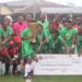 Shaita Angels FC celebrate with trophy and symbolic $1,000 check after winning the inaugural Caresyburg International Cup in 2024.