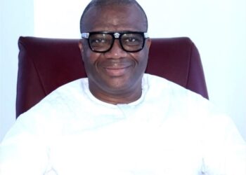 MPC leader Simeon Freeman smiling in white attire while advocating for 4-year political terms in Liberia