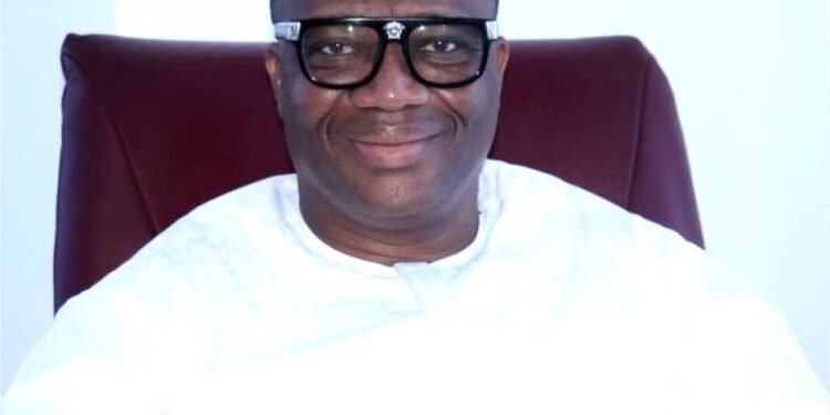 MPC leader Simeon Freeman smiling in white attire while advocating for 4-year political terms in Liberia