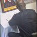 Former Liberian President George Weah signs the Book of Condolence in Abuja for late Nigerian President Muhammadu Buhari, whose framed portrait is displayed beside him, during a solemn tribute honoring Buhari’s legacy as a regional pillar of stability