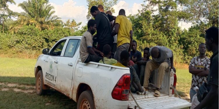 FDA patrol vehicle carrying arrested Burkinabé cocoa farmers suspected of clearing protected forestland in Grand Gedeh County