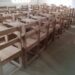 Wooden school armchairs arranged in a classroom in rural Grand Kru County