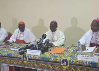 Four senior Catholic bishops of Côte d’Ivoire seated at a press conference table in Abidjan, delivering a pastoral letter on electoral reform ahead of the 2025 presidential election.