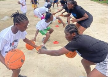 Young Liberian girls practice basketball drills during the Flames Basketball youth camp in Monrovia, guided by FIBA-certified coaches.