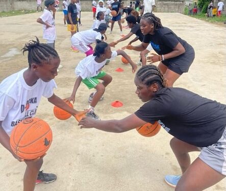 Young Liberian girls practice basketball drills during the Flames Basketball youth camp in Monrovia, guided by FIBA-certified coaches.