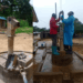 Side-by-side image showing a damaged hand pump and technicians from the Binda Foundation repairing a pump to restore clean water access in Smith Town, Gbarpolu County.