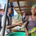 A female vendor in Sirleaf Market, Gbarnga, Bong County, speaks to a local journalist about new Liberian hospital fees affecting poor citizens