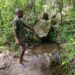 Bong County resident pointing to a shallow bush water source still used for drinking in Laykai-Ta village