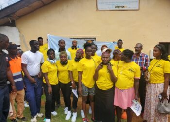 Rehabilitated women in yellow shirts pose after graduating from Liberia’s Center for Rehabilitation and Reintegration during an anti-drug rally in Paynesville