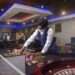 Casino dealer in uniform arranging chips on a roulette table at 50/50 Casino in Monrovia, Liberia.