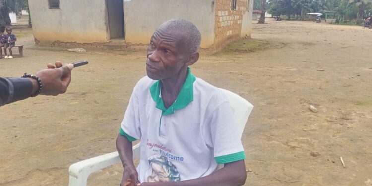 Elderly man being interviewed about Gbarney Public School’s challenges in Bong County, Liberia.