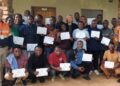 Group photo of participants and staff from ArcelorMittal Liberia Training Academy and African Bible College University after teacher training completion