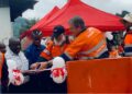 ArcelorMittal Liberia executives and community leaders cut ribbon to dedicate new solar-powered water kiosks in Yekepa, Nimba County.